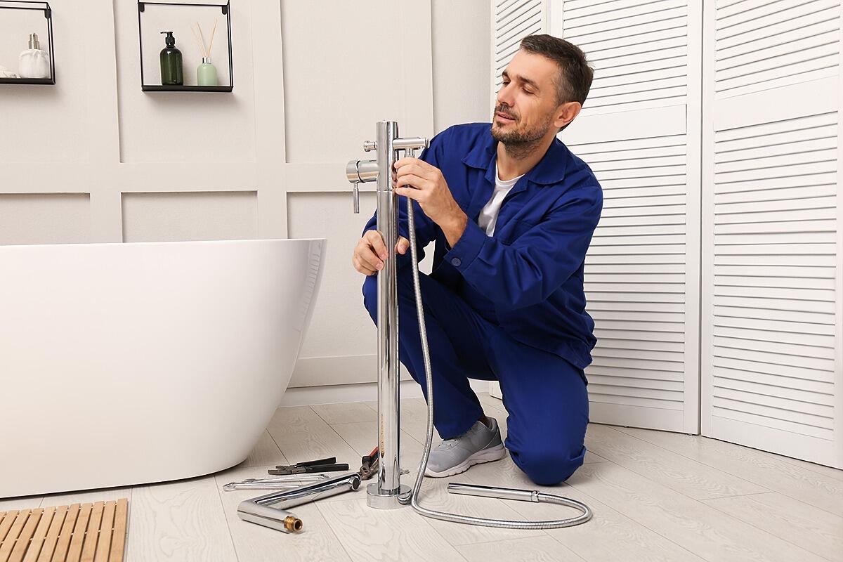 ClearFlow plumber finishing a chrome faucet installation